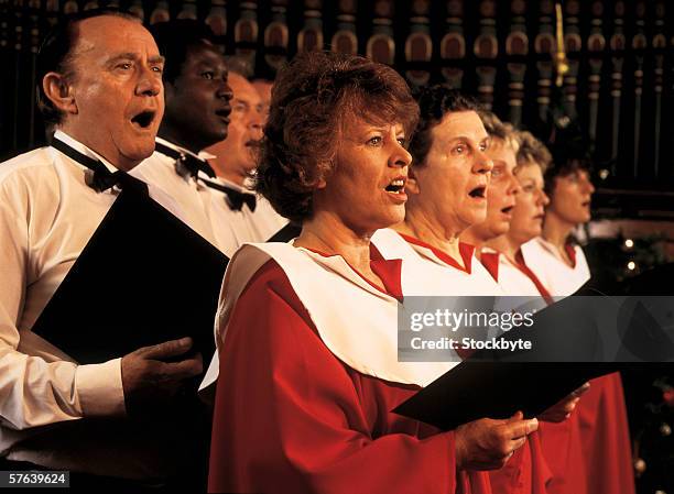 women and men singing in a church choir - choir imagens e fotografias de stock