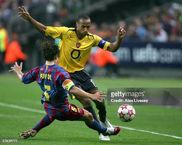 Thierry Henry of Arsenal is challenged by Carles Puyol of Barcelona during the UEFA Champions League Final between Arsenal and Barcelona at the Stade...