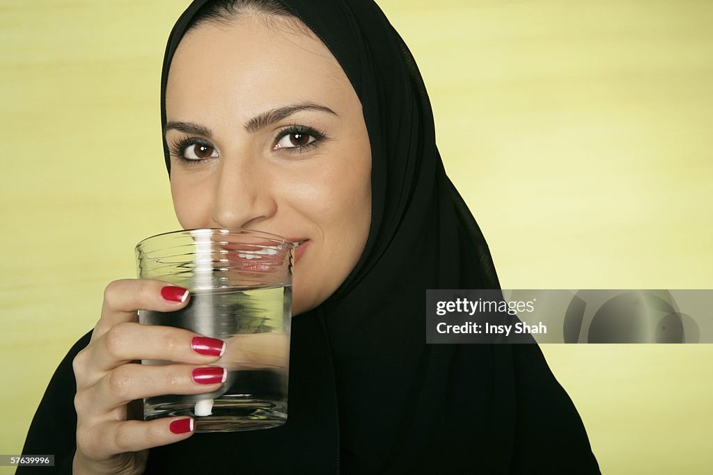 Arab lady with a glass of water.