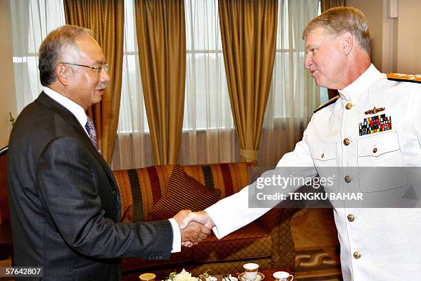 Kuala Lumpur, MALAYSIA: Malaysian Deputy Prime Minister Najib Razak shakes hands with US Pacific Fleet Commander Admiral Gary Roughead at the...