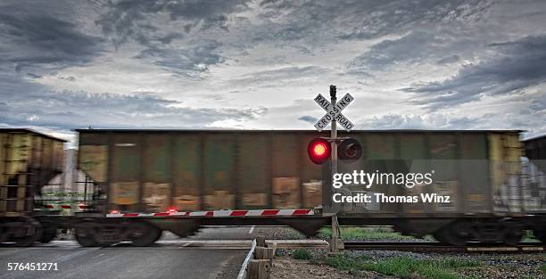 freight train and railroad crossing - 貨物列車 ストックフォトと画像