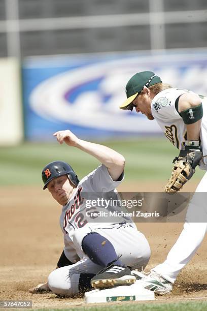 Chris Shelton of the Detroit Tigers slides into first base during the game against the Oakland Athletics at the Network Associates Coliseum in...