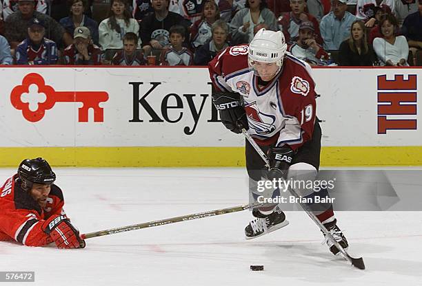 Captain Joe Sakic of the Colorado Avalanche shoots and scores as Scott Stevens reaches out unsuccessfully in the second period during Game 1 of the...