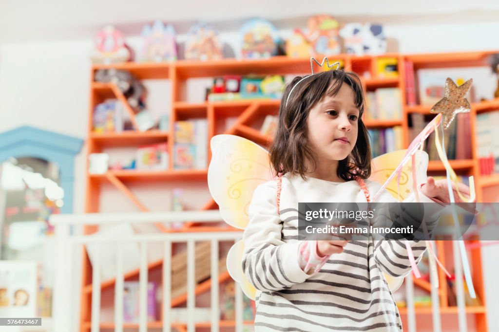 Girl in stripy jumper with fairy wings