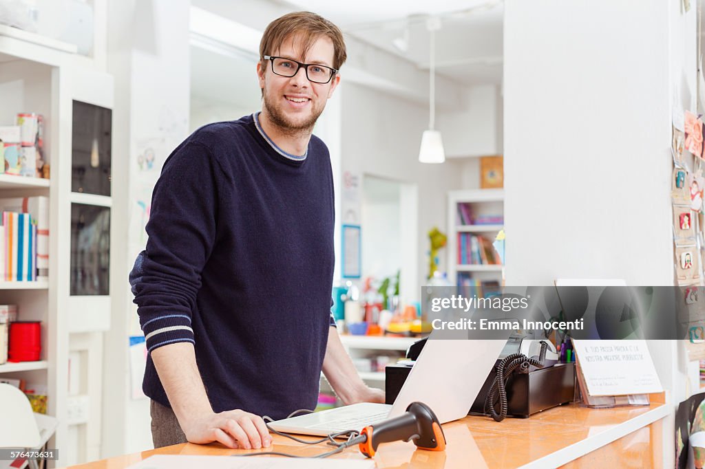 Independent business owner at cash register