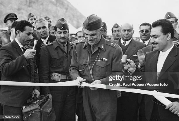 Iraqi Prime Minister Abd al-Karim Qasim cuts the tape at the inauguration of the Darbandikhan Dam on the Diyala River in Sulaymaniyah, Iraq on...