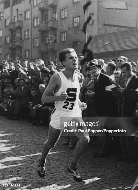 Czech marathon runner Pavel Kantorek pictured running past crowds of spectators during a marathon road race circa 1960.