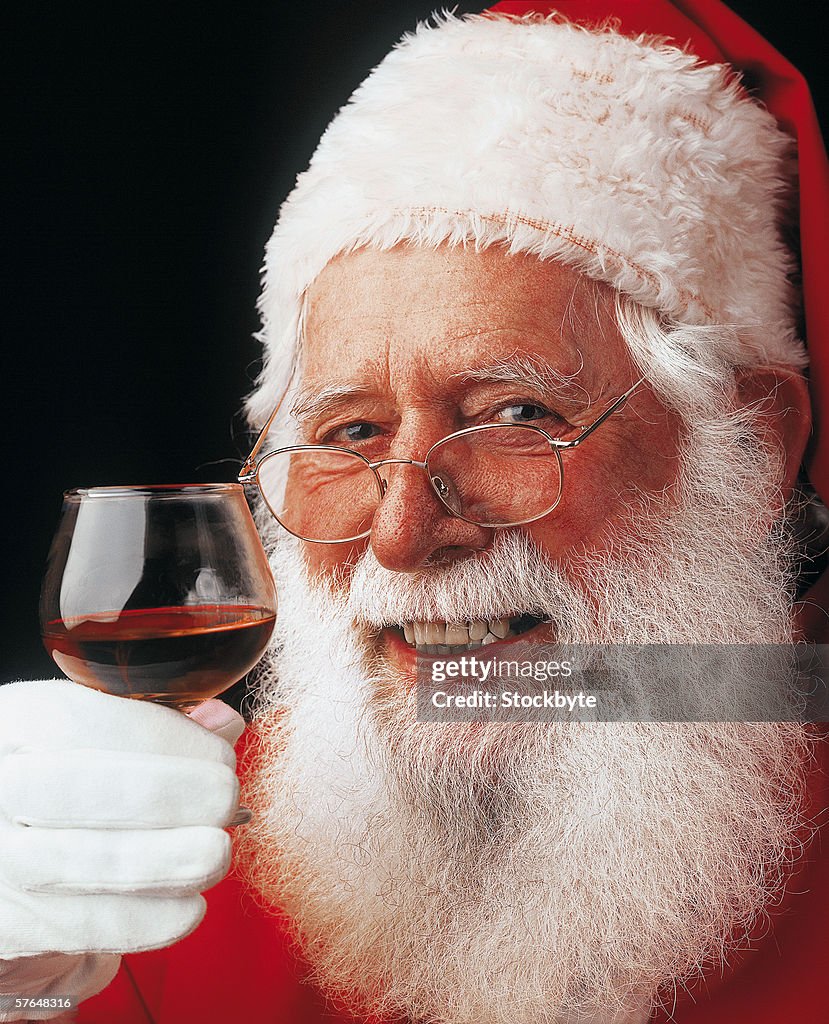 Portrait of Santa holding glass of red wine