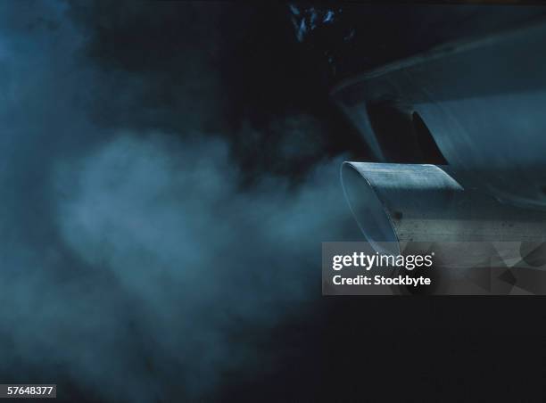 a exhaust pipe of a car emitting fumes - car pollution stock pictures, royalty-free photos & images