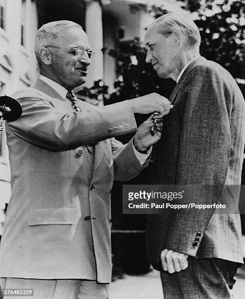 President of the United States, Harry S Truman presents the Distinguished Service Medal to Harry Hopkins, aide to the late President Roosevelt and...