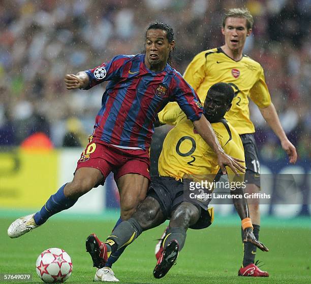 Ronaldinho of Barcelona is tackled by Emmanuel Eboue of Arsenal during the UEFA Champions League Final between Arsenal and Barcelona at the Stade de...
