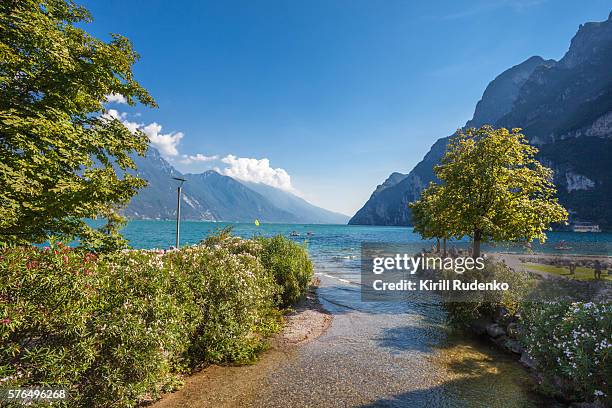 tributary of the river sarca entering lake garda - riva del garda stock pictures, royalty-free photos & images