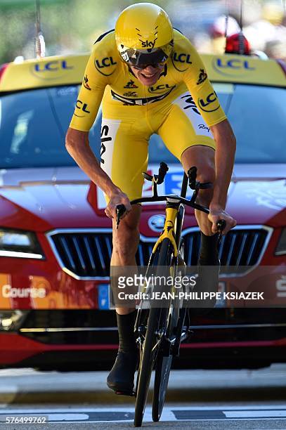Great Britain's Christopher Froome, wearing the overall leader's yellow jersey, crosses the finish line of the 37,5 km individual time-trial, the...