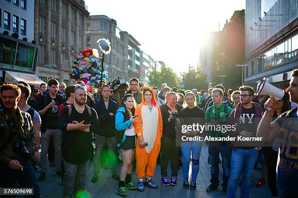 Young players walk through the city centre of Hanover while holding their smartphones and playing "Pokemon Go" on July 15, 2016 in Hanover, Germany....