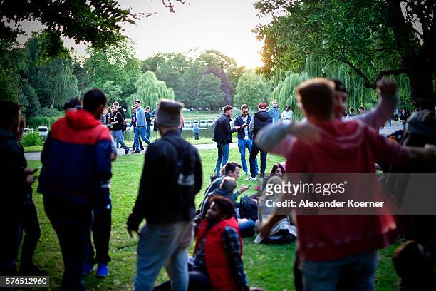 Young players stand at the Maschpark while holding their smartphones and playing "Pokemon Go" on July 15, 2016 in Hanover, Germany. 1.200 players...
