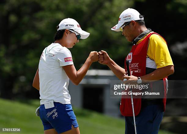 Hyo Joo Kim of South Korea celebrates finishing her round tied for the lead with her caddie on the 18th green during the second round of the Marathon...