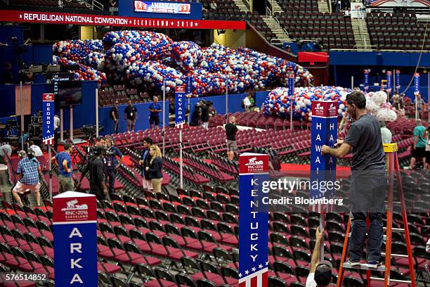 Worker installs a Hawaii state placard inside the Quicken Loans Arena "The Q" ahead of the Republican National Convention in Cleveland, Ohio, U.S.,...