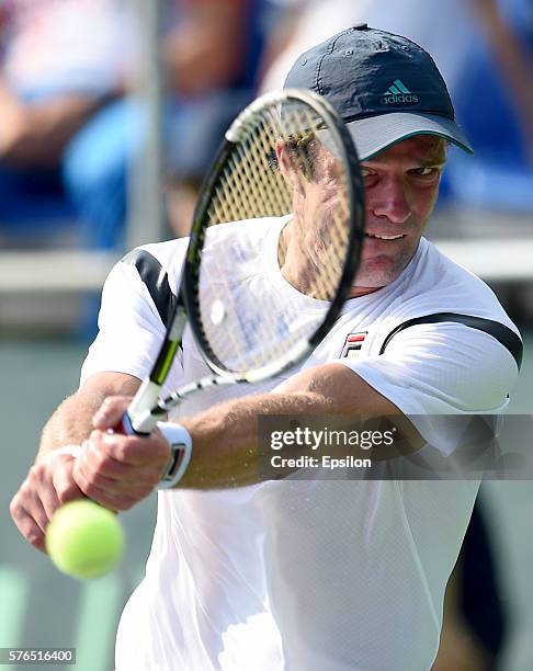 Teymuraz Gabashvili of Russia returns the ball to Thiemo De Bakker of Netherlands during the Davis Cup second round tie between Russia and the...