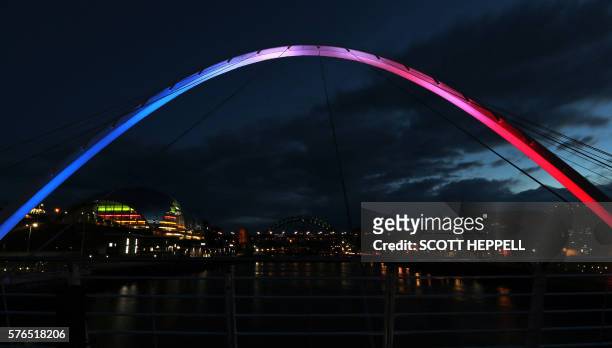 The Gateshead Millennium Bridge which spans the River Tyne is is illuminated in blue, white and red lights, resembling the colours of the French...