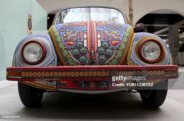 The "Vochol", a 1990 Volkswagen Beetle decorated by members of Mexican Huichol indigenous group with 2 000 chaquiras beads, is exhibited at the Folk...