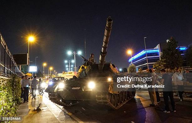 People gather near the Turkish army's tank near Ataturk Airport on July 16, 2016 in Istanbul, Turkey. Istanbul's bridges across the Bosphorus, the...