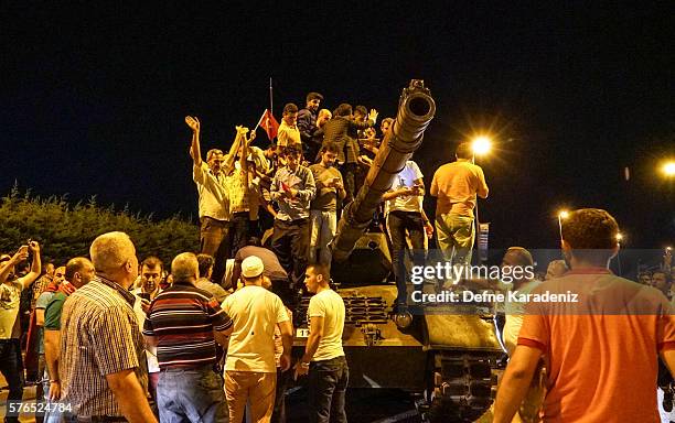 People gather on top of a Turkish armys tanks at Ataturk Airport on July 16, 2016 in Istanbul, Turkey. Istanbul's bridges across the Bosphorus, the...