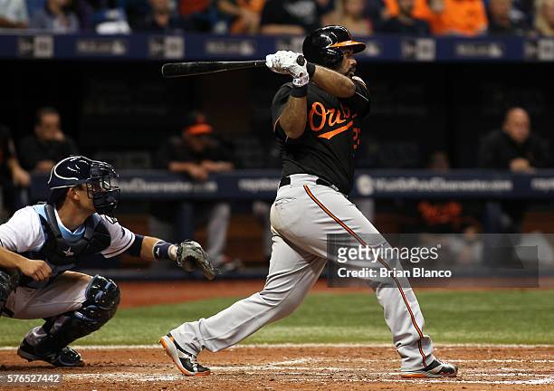 Pedro Alvarez of the Baltimore Orioles hits an RBI double in front of catcher Luke Maile of the Tampa Bay Rays to score J.J. Hardy during the fifth...