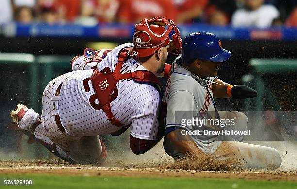Juan Lagares of the New York Mets slips under the tag of Cameron Rupp of the Philadelphia Phillies in the seventh inning at Citizens Bank Park on...