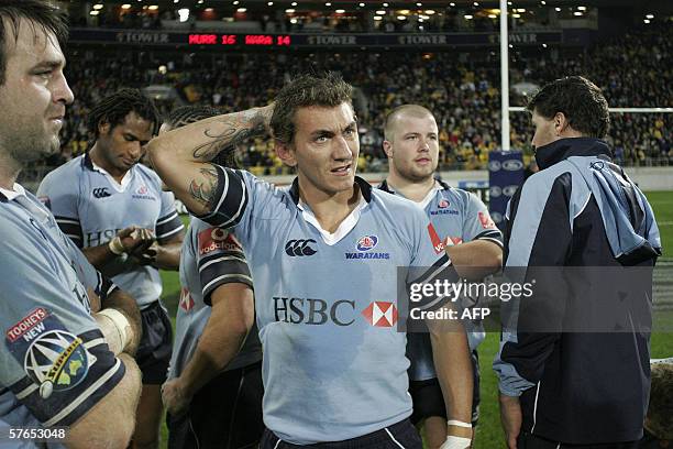 Wellington, NEW ZEALAND: Mat Rogers the Waratahs stands dejected amongst his teammates after losing the Super 14 semi final match between the...