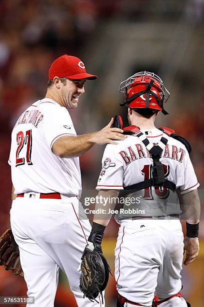 Ross Ohlendorf and Tucker Barnhart of the Cincinnati Reds celebrate after the final out in the ninth inning against the Milwaukee Brewers at Great...