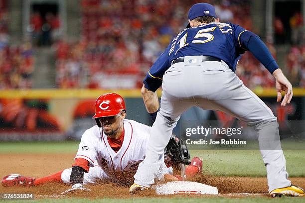 Billy Hamilton of the Cincinnati Reds steals third base ahead of the throw to Will Middlebrooks of the Milwaukee Brewers in the seventh inning at...