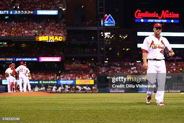 Reliever Trevor Rosenthal of the St. Louis Cardinals returns to the dugout after being pulled from the gam against the Miami Marlins in the seventh...