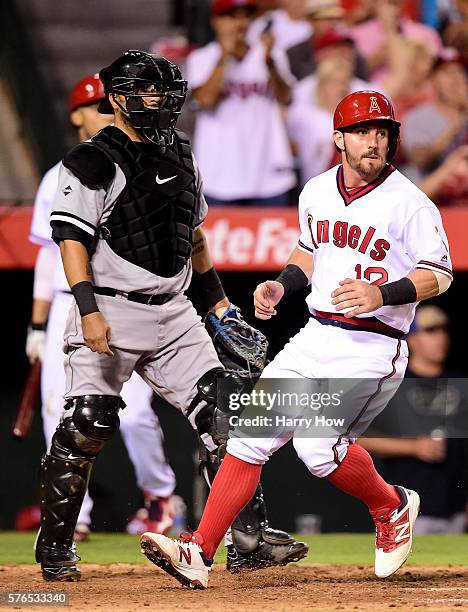 Johnny Giavotella of the Los Angeles Angels scores a run in front of Dioner Navarro of the Chicago White Sox during the seventh inning at Angel...