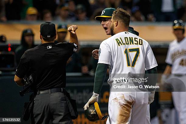 Bob Melvin of the Oakland Athletics and Yonder Alonso are ejected after arguing a called third strike by umpire Mark Wegner during the fourth inning...