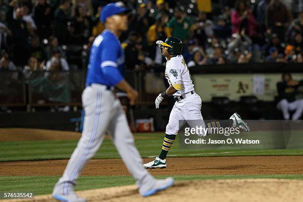 Khris Davis of the Oakland Athletics rounds the bases after hitting a two run home run off of Marcus Stroman of the Toronto Blue Jays during the...
