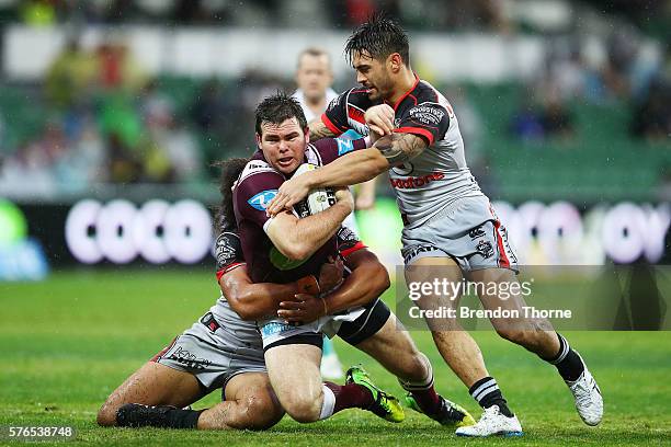 Jamie Lyon of the Sea Eagles is tackled by Shaun Johnson of the Warriors during the round 19 NRL match between the Manly Sea Eagles and the New...