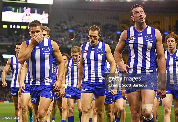 Andrew Swallow, Drew Petrie, Todd Goldstein and Ben Brown of the Kangaroos look dejected as they leave the field during the round 17 AFL match...