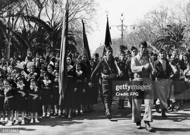 Nationalist troops march through Malaga on their way to a victory celebration, after capturing the city during the Spanish Civil War, 16th February...