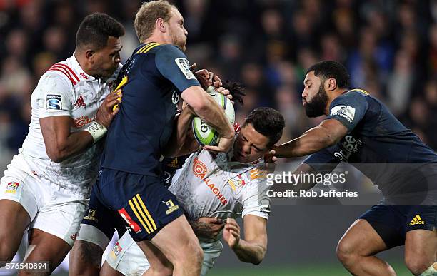 Anton Lienert-Brown of the Chiefs is wrapped up by Matt Faddes of the Highlanders during the round 17 Super Rugby match between the Highlanders and...