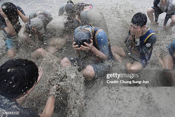 Festival-goers enjoy the mud during the annual Boryeong Mud Festival at Daecheon Beach on July 16, 2016 in Boryeong, South Korea. The mud, which is...