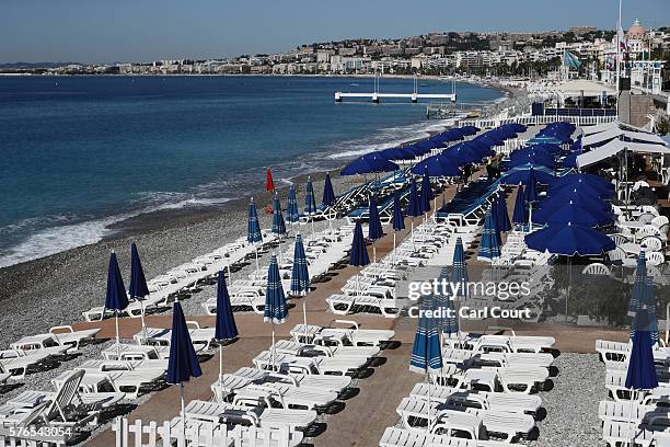 Sun loungers sit empty on the beach on the Promenade des Anglais on July 16, 2016 in Nice, France. Five people believed to be linked to the man who...