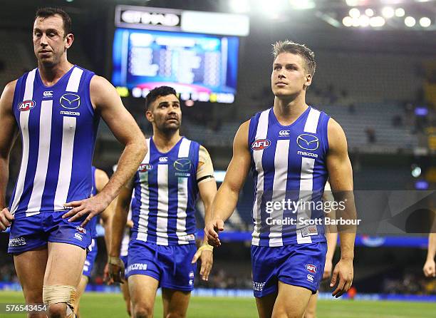 Andrew Swallow of the Kangaroos leads his side from the field after losing the round 17 AFL match between the North Melbourne Kangaroos and the Port...