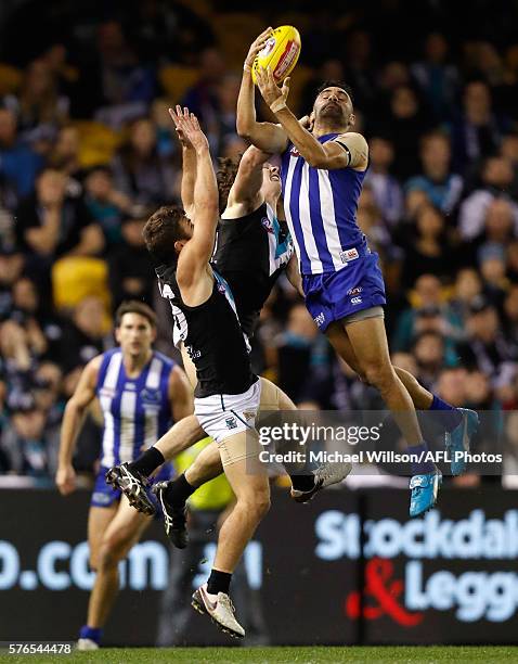 Lindsay Thomas of the Kangaroos attempts to mark over Sam Gray and Darcy Byrne-Jones of the Power during the 2016 AFL Round 17 match between the...