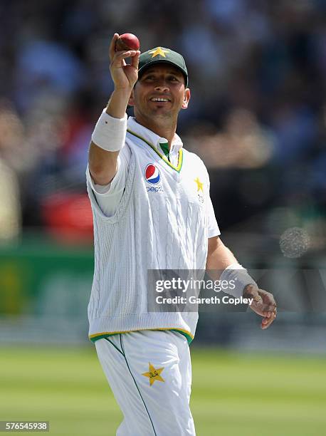 Yasir Shah of Pakistan holds up the ball as he leaves the field after picking a six wicket haul during day three of the 1st Investec Test between...