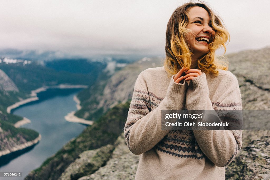 Girl laughing on the Trolltunga