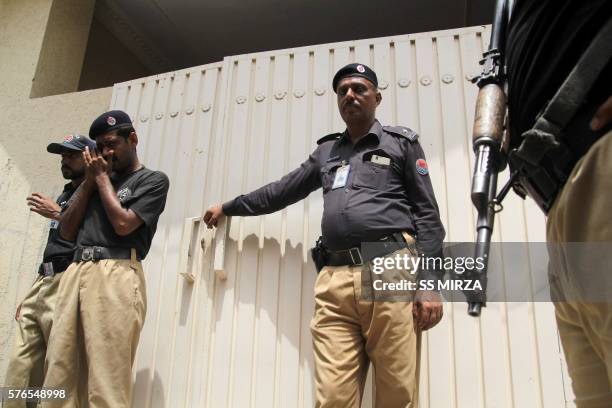 Pakistani policemen stand guard outside the house of social media celebrity, Qandeel Baloch who was murdered by her brother, in Multan on July 16,...