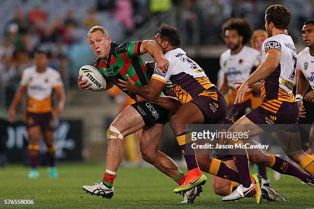 Jason Clark of the Rabbitohs is tackled during the round 19 NRL match between the South Sydney Rabbitohs and the Brisbane Broncos at ANZ Stadium on...
