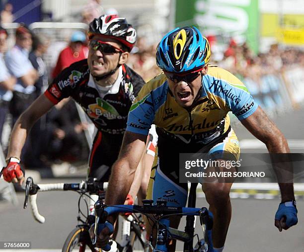 Spanish Adolfo Garcia Quesada celebrates his victory on the finish line over David Arroyo during the fifth stage of Catalunya's Tour, Llivia to...