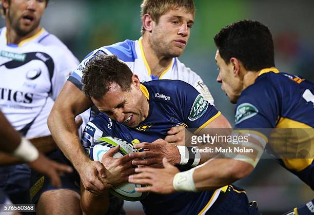 Andrew Smith of the Brumbies is tackled during the round 17 Super Rugby match between the Brumbies and the Force at GIO Stadium on July 16, 2016 in...