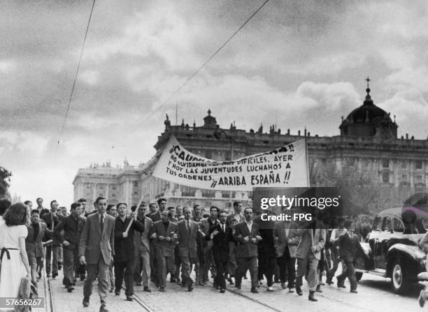 Young Spanish men march past the Palacio Real de Madrid to celebrate the 17th anniversary of Generalisimo Francisco Franco's rise to power, 10th May...